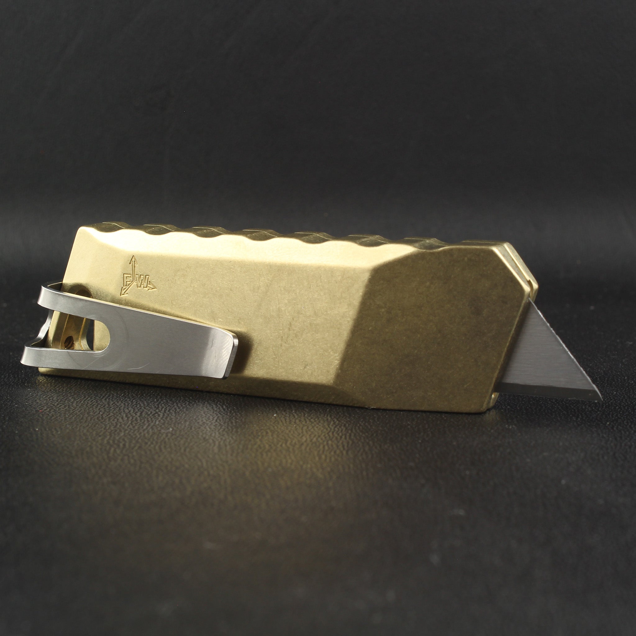 backside of focusworks bob the boxcutter in brass with pocket clip