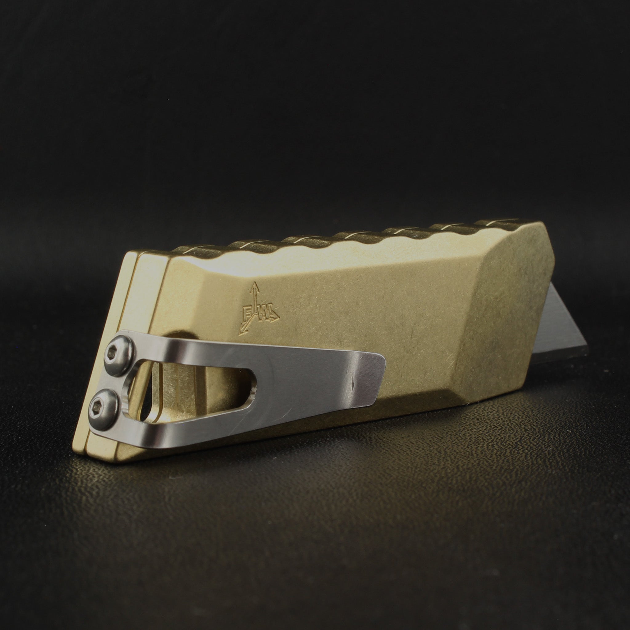backside of focusworks bob the boxcutter in brass with pocket clip