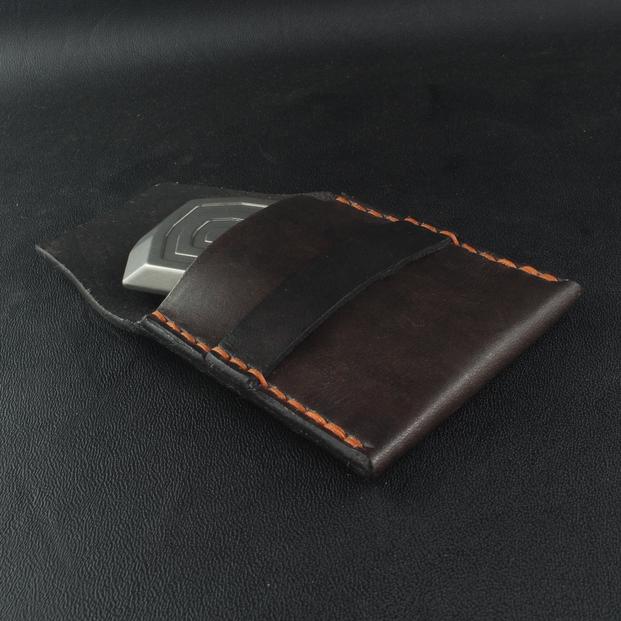 nomad titanium magnetic slider in a leather pouch